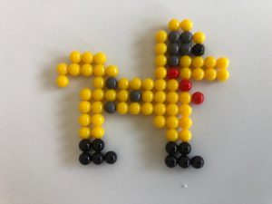 A dog character created from the magic beads game